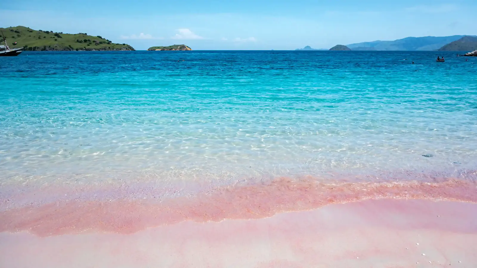 Pink sand shoreline meeting clear turquoise water at Pink Beach, Komodo National Park