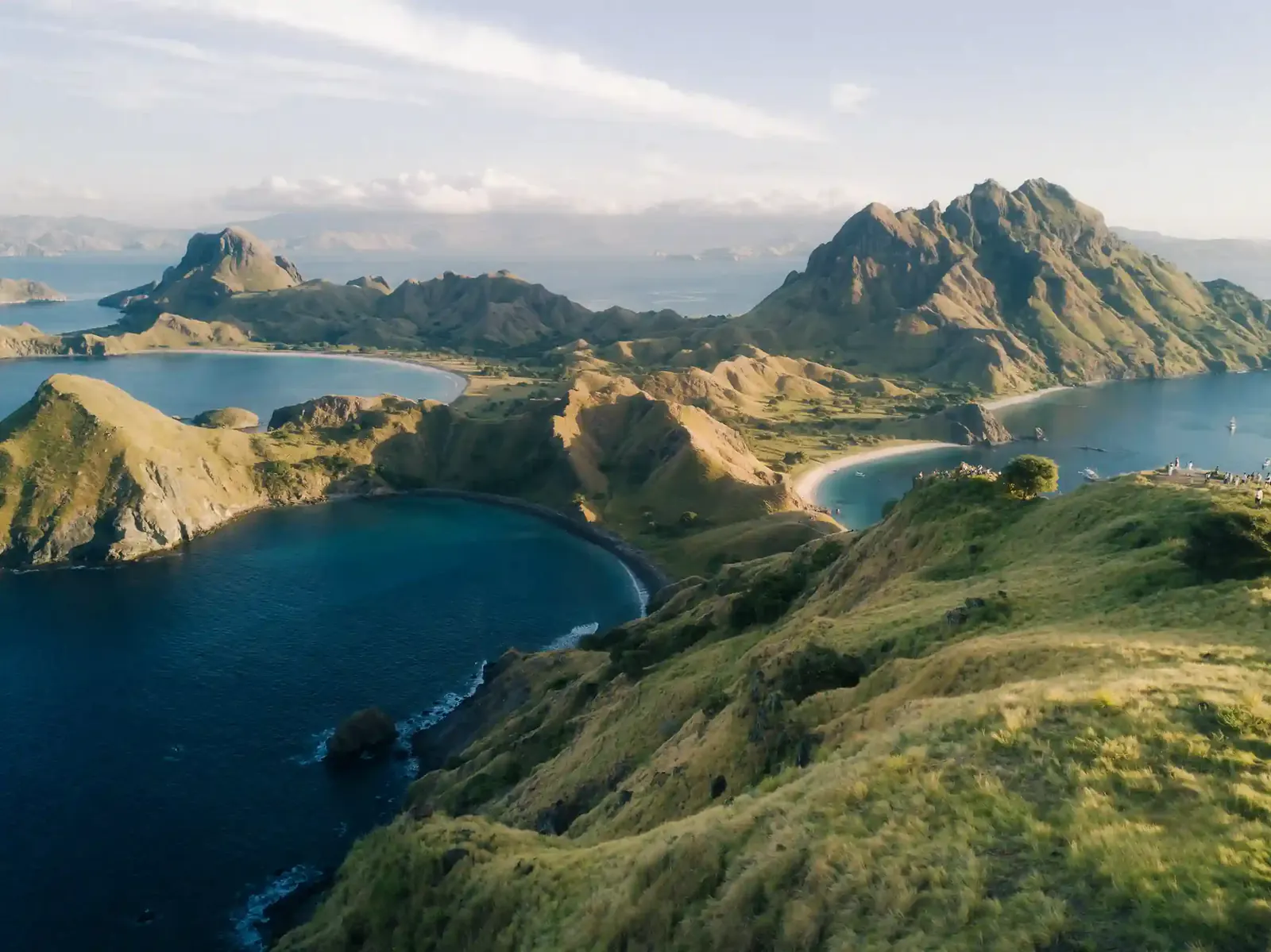Padar Island viewpoint over three curving bays, green ridges and jagged peaks in Komodo National Park